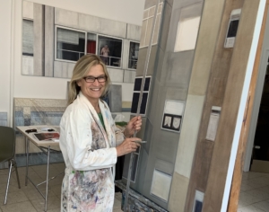 Susanna Storch in her studio, painting on a big canvas